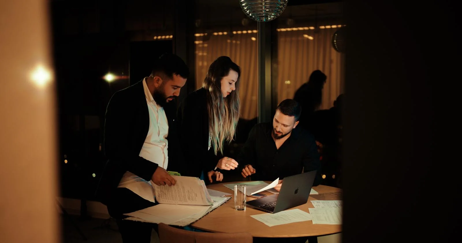 The Infinity Finance team around a work table